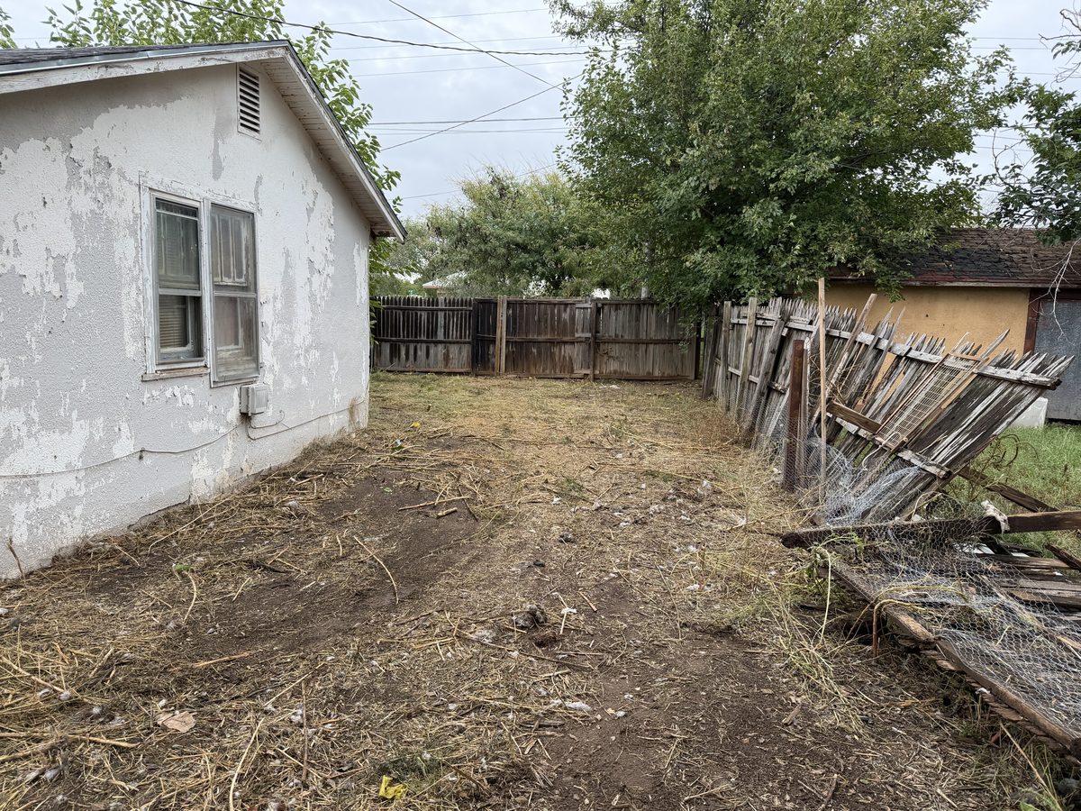 The same backyard after the cleanup, cleared down to the dirt